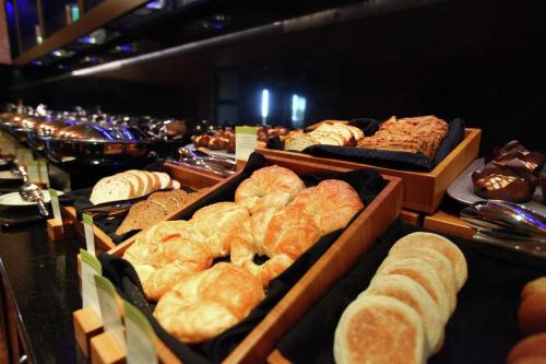 a display of different types of breads and pastries at Hilton Garden Inn Des Moines Airport in Des Moines