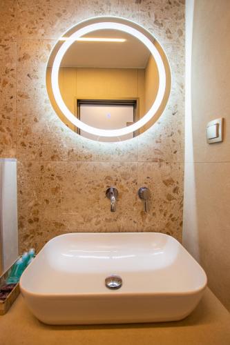 a white sink in a bathroom with a mirror at Haus Riviera in Asprovalta
