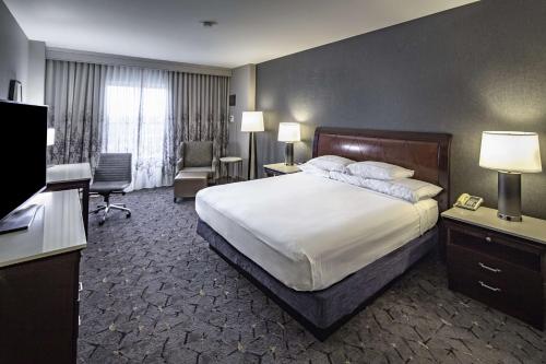 a hotel room with a bed and a television at DoubleTree by Hilton Modesto in Modesto