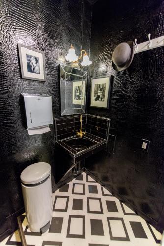a black and white bathroom with a toilet and a sink at The Rosemary in Los Angeles
