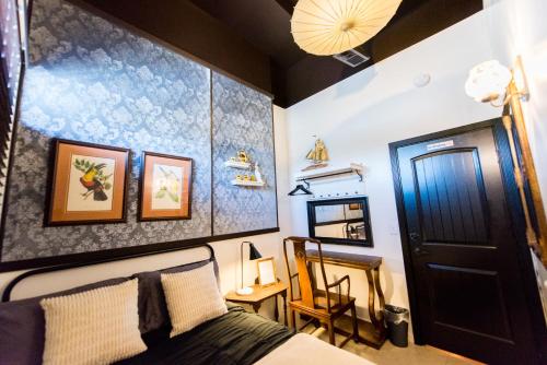 a bedroom with a bed and a table with a chair at The Rosemary in Los Angeles