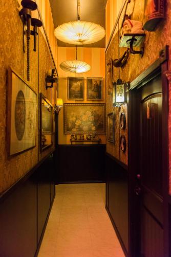 a hallway in a building with pictures on the walls at The Rosemary in Los Angeles