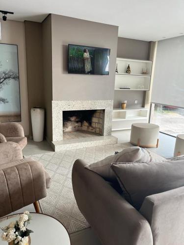 a living room with a couch and a fireplace at HOTEL BARLOS ADUANA in Uruguaiana