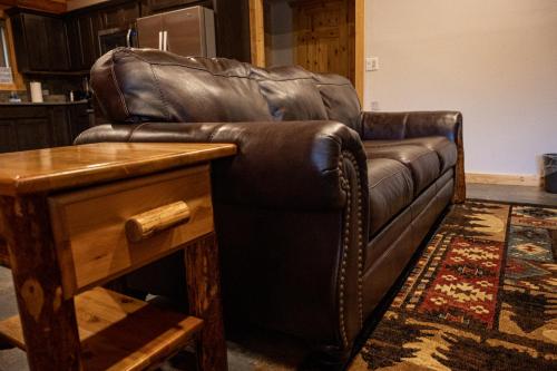 a brown leather couch sitting in a living room at North Haven Campground in Bonners Ferry