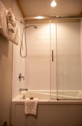 a bathroom with a shower and a bath tub at North Haven Campground in Bonners Ferry