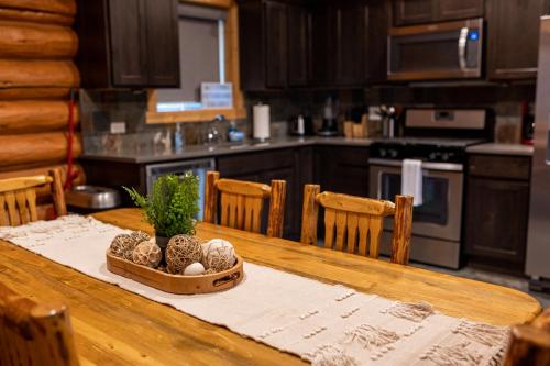 a kitchen with a wooden table with a table sidx sidx sidx at North Haven Campground in Bonners Ferry