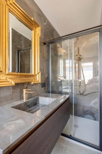 a bathroom with a sink and a glass shower at 5E Villa Charme-Sea and Ortigia view-Whirlpool roof Terrace in Siracusa