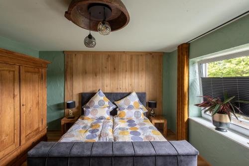 a bedroom with a bed with a pillow on it at Einzigartige Traumwohnung mit Whirlpool & Sauna bietet Luxus und Erholung in Neuheilenbach