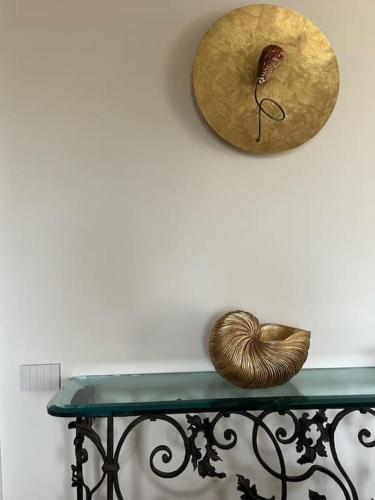 a green table with two items on a wall at 5E Villa Charme-Sea and Ortigia view-Whirlpool roof Terrace in Siracusa
