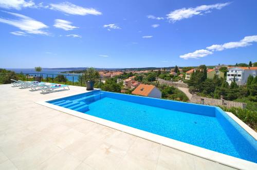 a swimming pool on the roof of a house at Unique Apartment with private pool in Krk