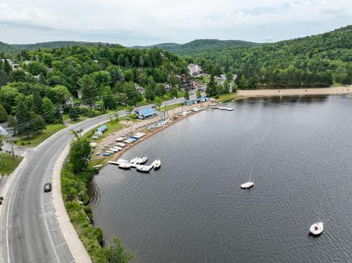 an aerial view of a lake with boats in the water at Les Lofts du Lac des Sables by Gestion ELITE in Sainte-Agathe-des-Monts