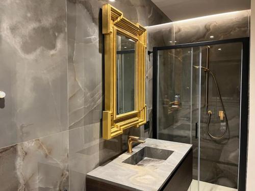 a bathroom with a sink and a shower with a mirror at 5E Villa Charme-Sea and Ortigia view-Whirlpool roof Terrace in Siracusa