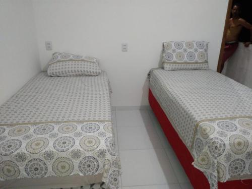 two beds sitting next to each other in a room at POUSADA ROSA DOS LENÇÓIS in Barreirinhas
