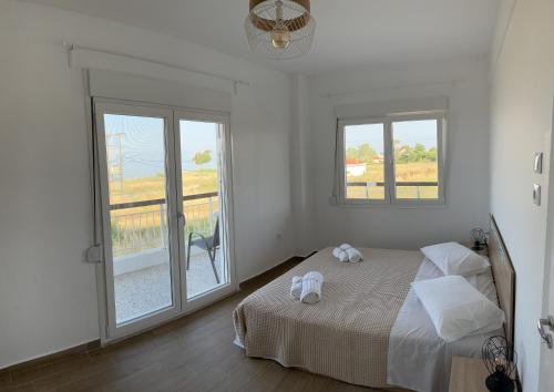a bedroom with a bed with two towels on it at Tsapoga in Pálioura