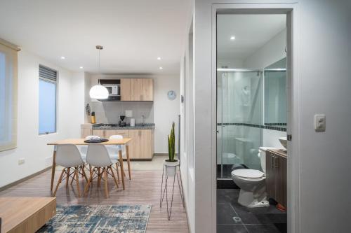 a kitchen and dining room with a table and chairs at Anima 64 in Bogotá