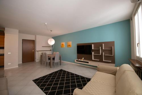 a living room with a couch and a tv at Alessi Appartamenti in Desenzano del Garda