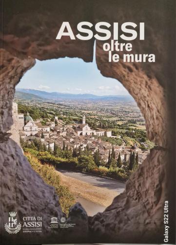 a view of a city through a rock window at Domus Mariae B&B Assisi in Assisi