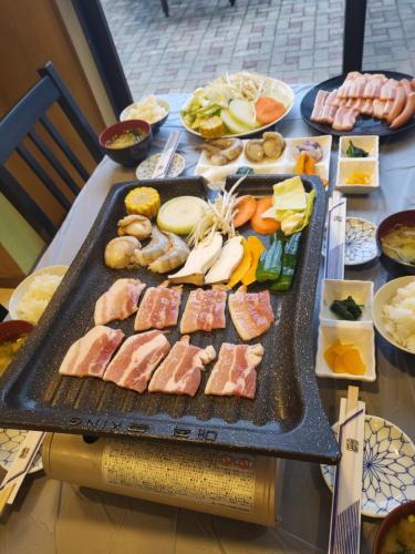 a table with a bunch of different types of food at Tsushima Dae-A Hotel in Tsushima