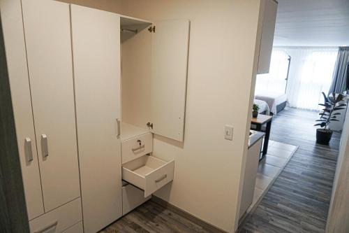 a bathroom with white cabinets and a sink at 86 suites in Bogotá
