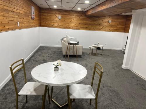 a meeting room with a white table and chairs at River Park South - 2 Bedroom Basement Suite in Winnipeg