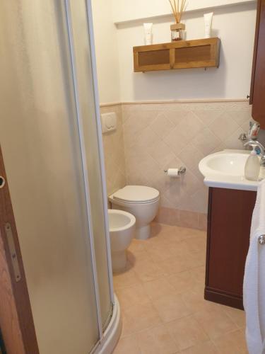 a bathroom with a toilet and a sink at La Casina di Checco in Marciana Marina