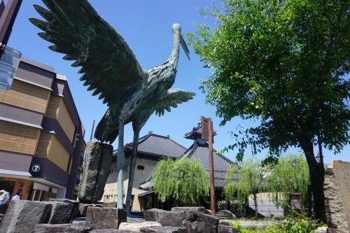 a statue of a bird in front of a building at Morizuya in Toyooka
