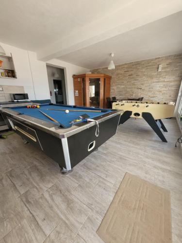a living room with a pool table and a ping pong ball at Villa Bosna Near Dubrovnik very beautiful Villa entirely privatized swimming pool, jacuzzi, sauna, billiard, ping-pong in Ivanica