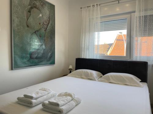 um quarto com uma cama com duas toalhas em Sunny apartment em Vršac