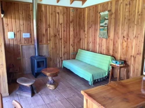 a room with a bed and a wood stove at Cabañas Amatista Neltume in Neltume
