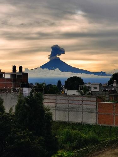 a mountain with a cloud on top of it at Departamento Xolotl (Dios guía y del fuego) in Cholula