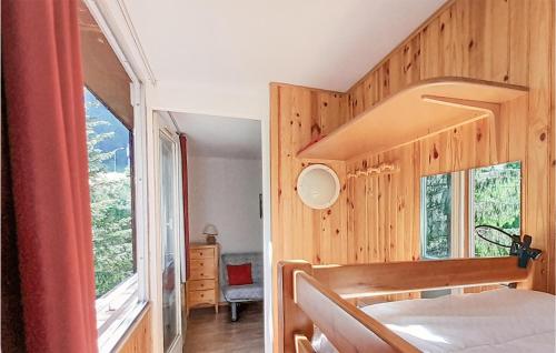 a bedroom with a bed and a large window at 1 Bedroom Lovely Apartment In Allos in La Foux