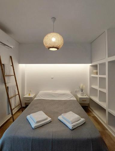 a bedroom with a bed with two towels on it at Josephine's place in Tinos