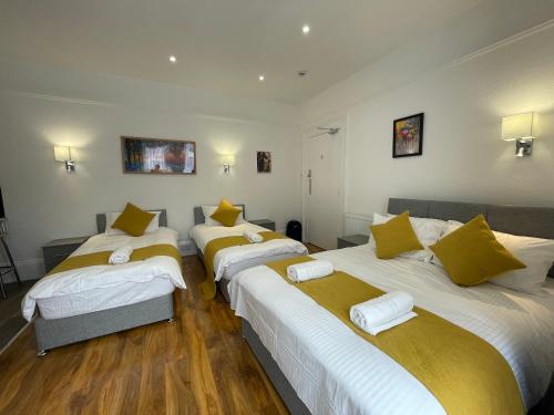 a group of four beds in a room at Station House Plymouth in Plymouth