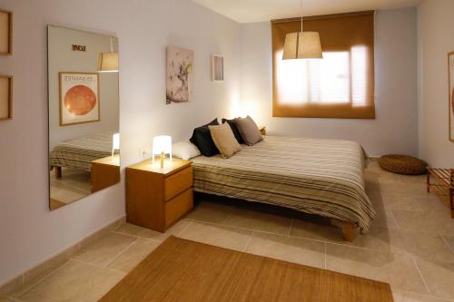 a bedroom with a large bed and a mirror at Mazi Apartments Martinet in Mataró