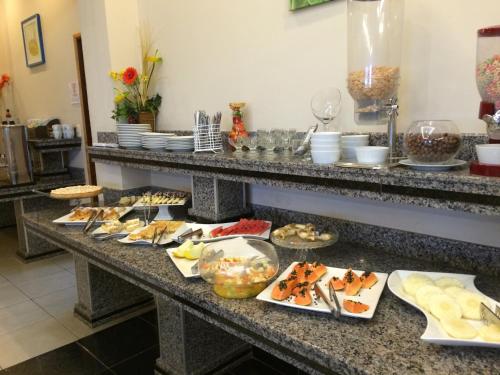 a buffet line with many different types of food at De La Costa Hotel in Encarnación