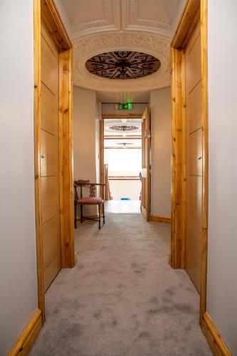 a hallway with a table and a ceiling at Pontcysyllte Chapel Tearoom in Llangollen