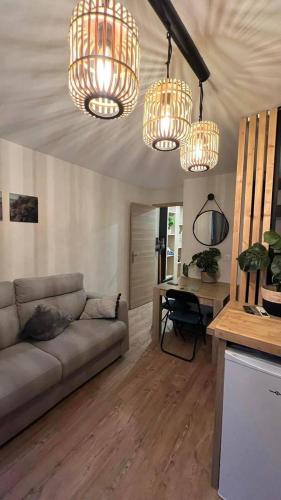 - un salon avec un canapé et des lustres dans l'établissement Location estival parfaite : Studio à 50 mètres de la plage, offrant une magnifique vue mer, à Fréjus