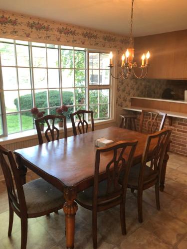 a dining room with a wooden table and chairs at Weaverling House- Historic Stay in Smalltown America in Everett