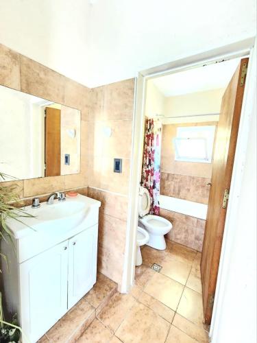 a bathroom with a white sink and a toilet at CASA EN VERTIENTES DE LA GRANJA in La Granja
