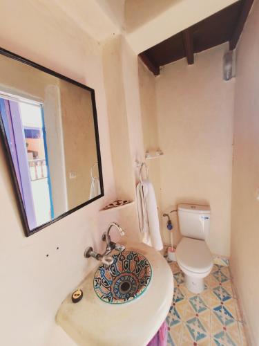 a bathroom with a sink and a toilet at Riad AYLAL in Essaouira