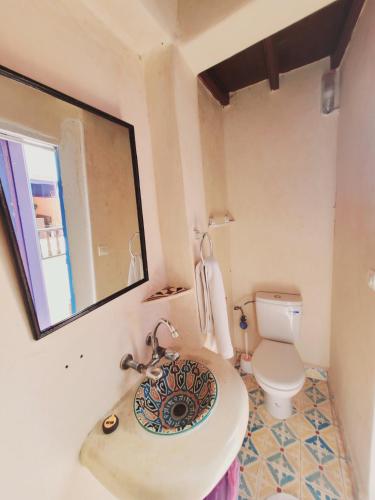 a bathroom with a sink and a toilet at Riad AYLAL in Essaouira