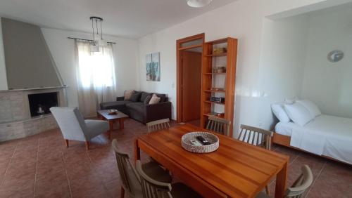 a living room with a table and a couch at Kristallia apartment with view - Kattavia in Kattavía