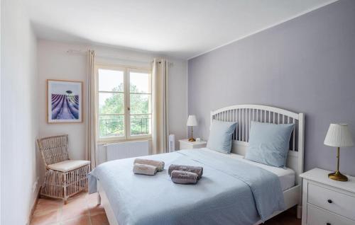 een slaapkamer met een wit bed met 2 kussens erop bij Villamombetti in Montauroux
