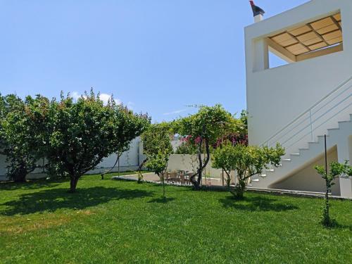 a view of the yard of a house with trees at Kristallia - Kattavia surf houses in Kattavía