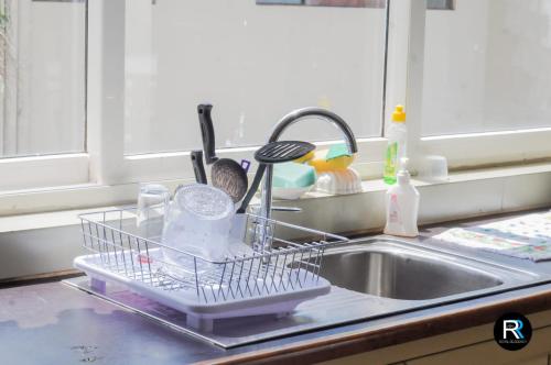 a dish drying rack on a sink in a kitchen at Royal Residency in Kandy