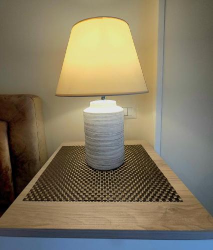 a table with a lamp on top of a table at B&B Donna Francè Pompei - Scafati in Scafati