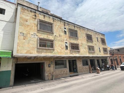 an old stone building on a city street at HOTEL JERUSALEM in San Juan de los Lagos