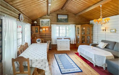 a living room with a table and a couch at Nice Home In bogen With House Sea View in Kongsvinger