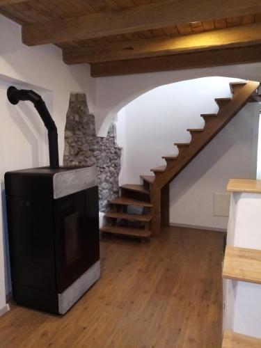 a living room with a fireplace and a staircase at Palazzo Vassallo3 in Pieve di Teco