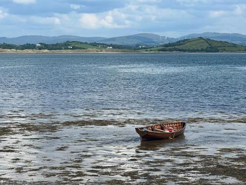 a boat sitting on the shore of a large body of water at In the country yet close to town in Carterʼs Bridge